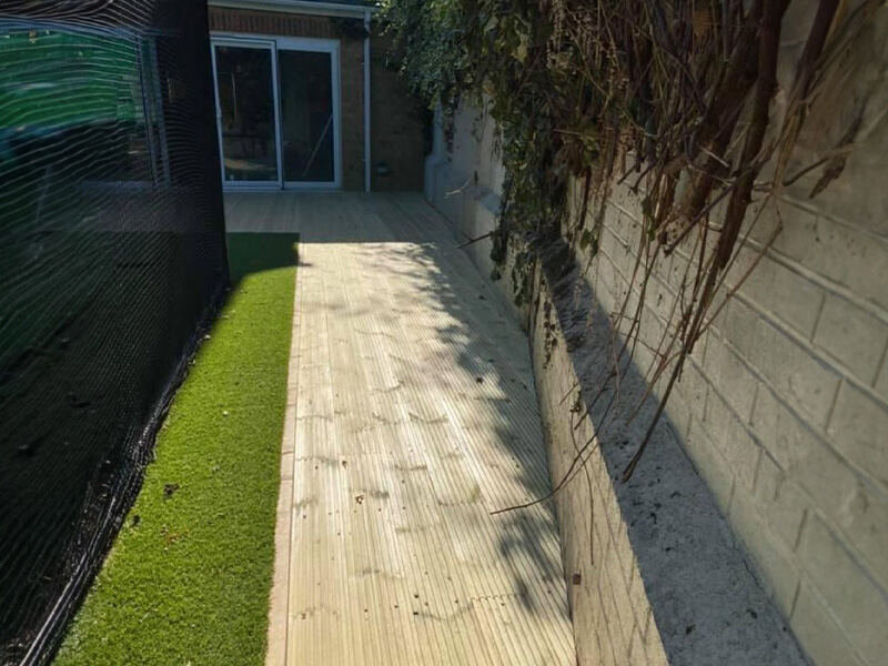 Decking walkway beside a lawn