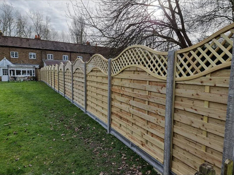 Decorative continental fence panels with concrete posts