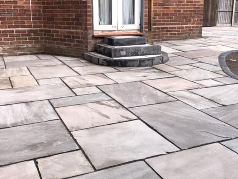 Indian sandstone patio with raised planter