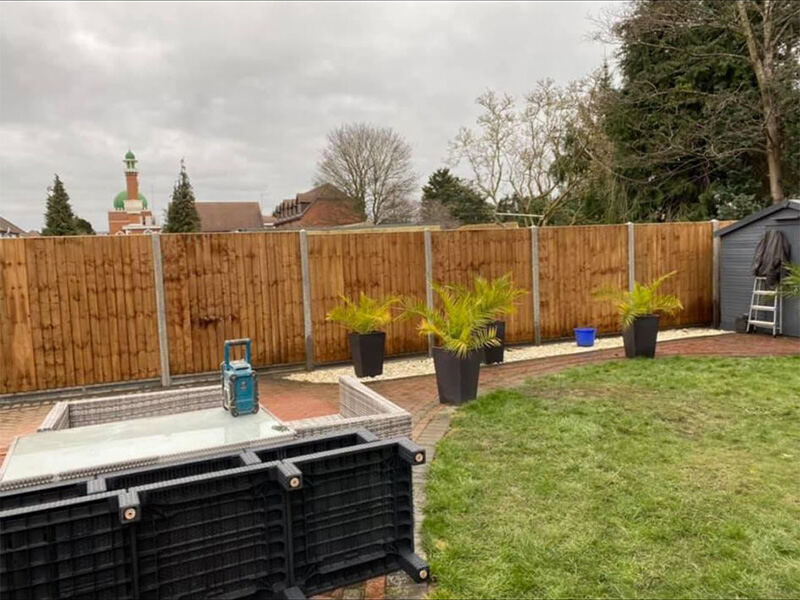 Timber garden fence with fresh lawn